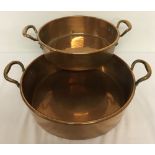 2 large round, 2 handled, shallow copper pans.