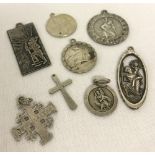 A collection of 9 silver and white metal St. Christopher and cross pendants.