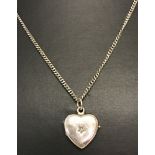 A small silver heart shaped locket set with a small central diamond on a 22" curb chain.