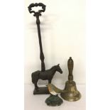2 metal door stops together with a wooden handled bell.
