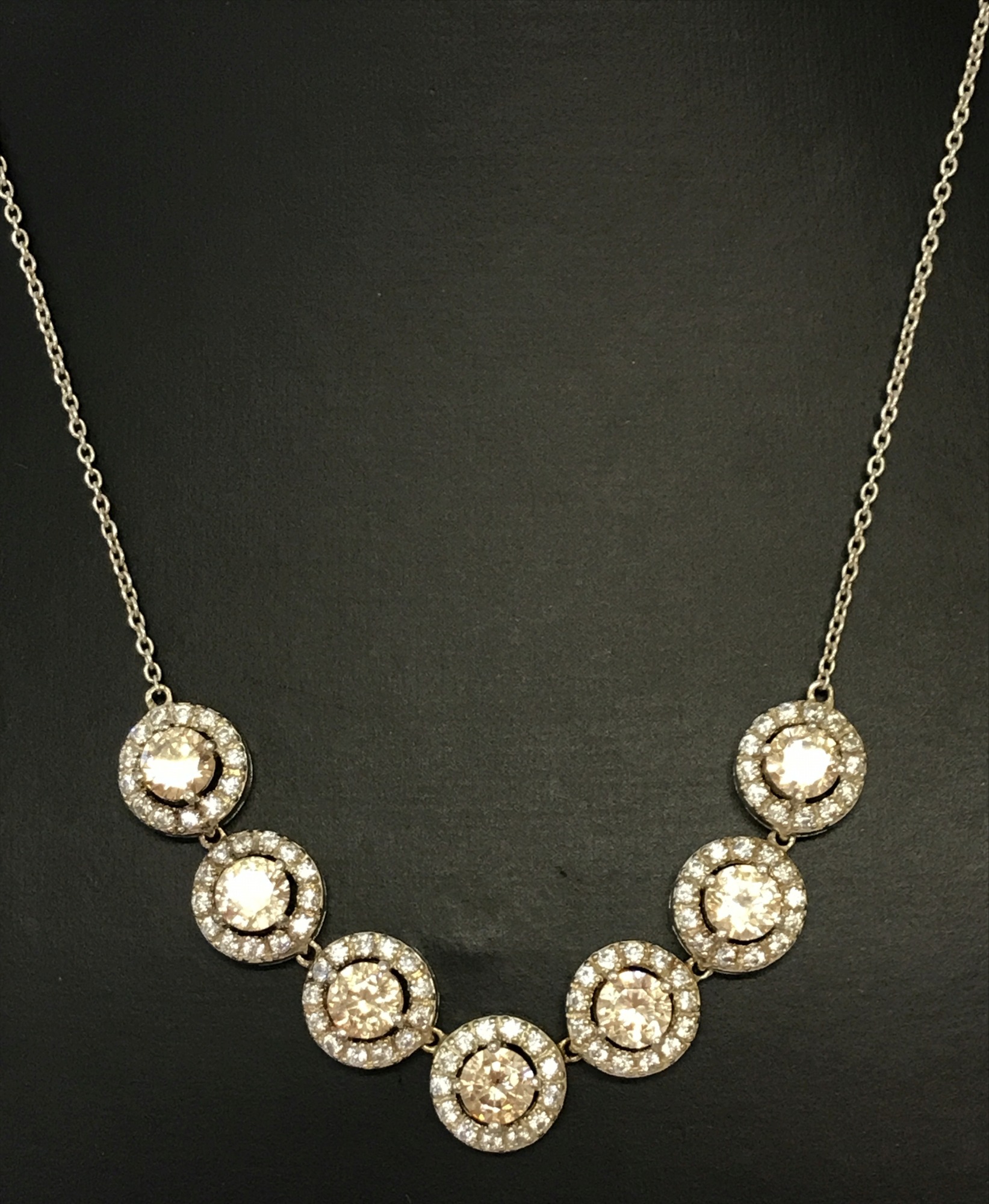 A decorative clear and champagne stone set dress necklace.
