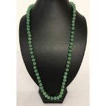 A 28" jade beaded necklace, knotted between each bead.