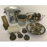 A collection of silver plated and metal items to include ice bucket, cake stand, goblets & egg cups.