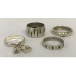 4 silver and white metal rings.