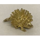 A 9ct gold charm in the shape of a hedgehog, complete with hanging bale.