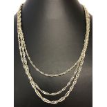 A graduating strand silver rope chain necklace.