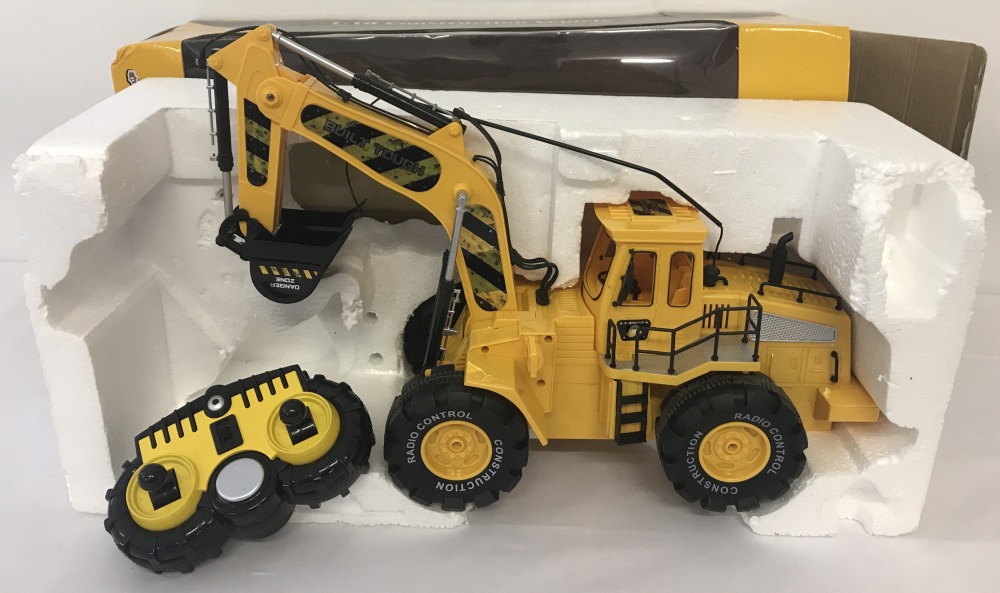 A boxed remote control 1:10 scale construction vehicle.