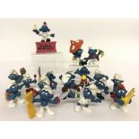 A collection of 17 vintage Smurfs by Peyo to include footballer, boxer, pirate and magician.