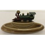 A circa 1960's Wade brown ceramic pin tray mounted with Matchbox diecast vehicle.