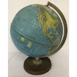 A vintage globe mounted on wooden plinth.