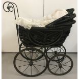 A reproduction vintage style dolls pram.