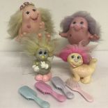 4 1980's Playskool "Snugglebums" together with their brushes & a hairband.