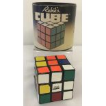 A vintage 1981 Rubik's cube by Ideal, in original cylindrical box.