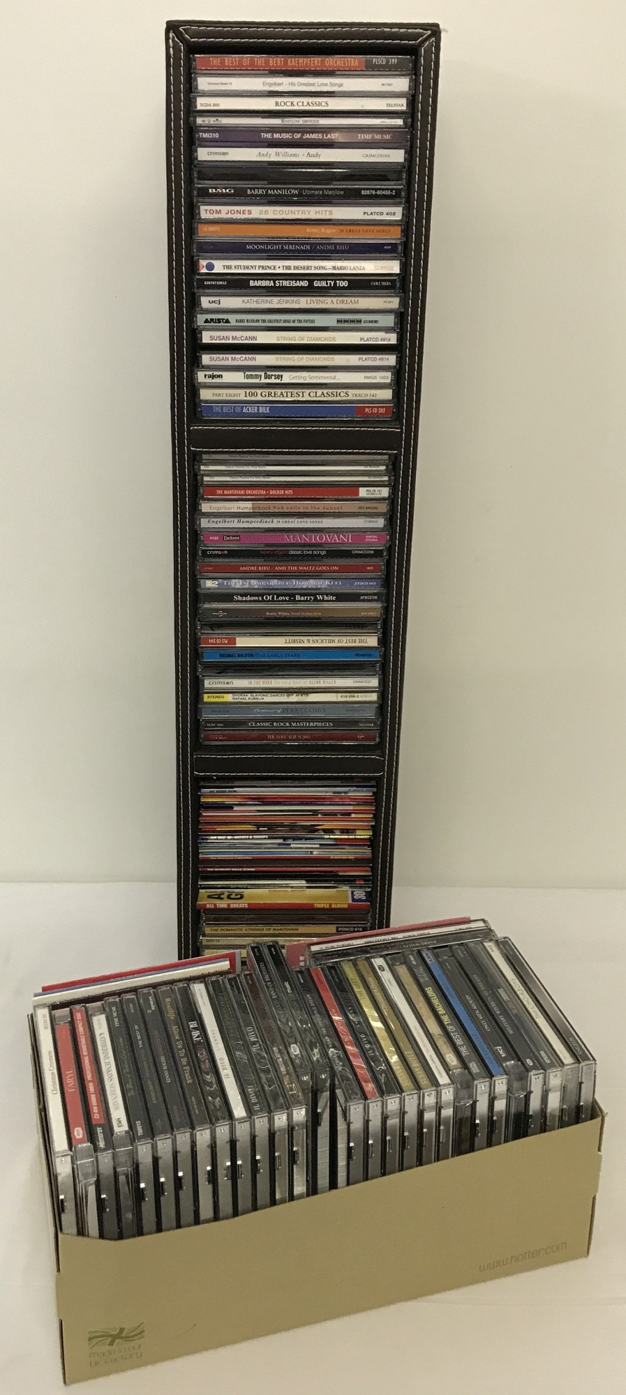 A large quantity of easy listening CD's together with a faux leather freestanding CD rack.