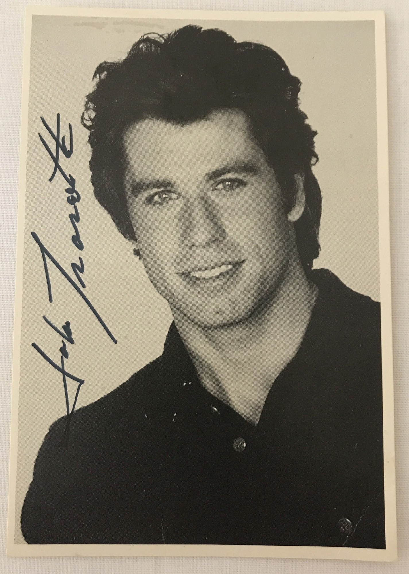 A signed black and white studio photo of John Travolta.