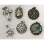 A collection of 6 silver and white metal pendants.
