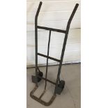 A vintage metal sack barrow with hard rubber wheels.