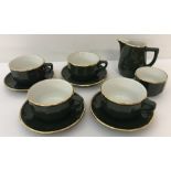 A vintage green & gold ceramic coffee set.