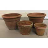 4 terracotta garden pots of differing sizes to include a pair with Greek key design to outer rim.