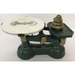 A set of vintage cast iron scales with ceramic plate and set of weights.