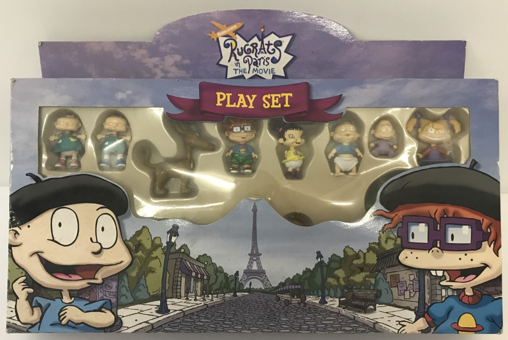 A boxed 2000 "Rugrats in Paris, The Movie" play set with figures, board and cardboard scenes.