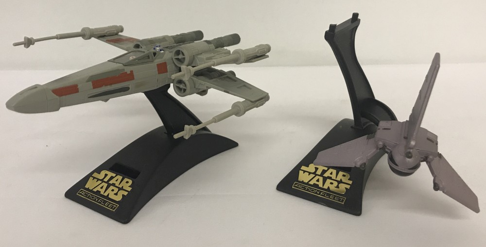 A 1995 Micro Machines Star Wars Action Fleet X Wing Fighter complete with figures inside and stand.