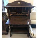 An Art Deco dark wood upright escritoire with under shelving.