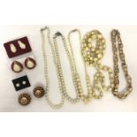 A small collection of vintage costume jewellery necklaces and earrings.