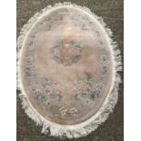 An oval Chinese wool rung with fringed ends.