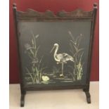 An Edwardian oak framed fire screen with glass panelled oil painting on fabric.