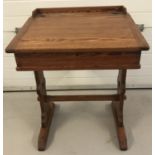 A vintage pitch pine school desk with lift up lid and interior stationary compartments.