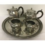 A 5 piece hammered design pewter tea set by Lenton Bros, Sheffield.