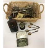 A small basket of metal ware items.