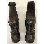 A pair of heavy solid dark wood African tribal man and woman figurines.