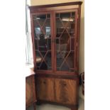 A Beresford & Hicks glass fronted corner display cabinet.
