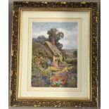 A colour print of a rural cottage scene in ornate gilt frame.