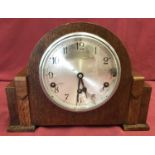 An Art Deco oak cased mantel clock with Westminster chime, in working order.