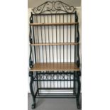 A heavy modern wrought iron and pine shelving unit, frame painted green.