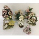 A box of capodimonte ceramic floral spray ornaments in matte finish.