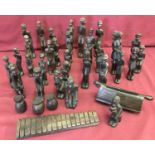 A large collection of carved dark solid wood tribal figures.