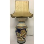 A large Chinese ceramic urn shaped table lamp with colourful dragon panel design.