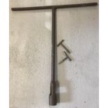 A large vintage railway track adjusting tool together with 2 others.