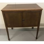 A vintage satin wood 2 door cupboard with interior shelf.