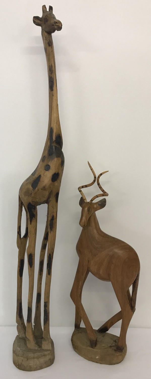 2 carved wooden animal figures. A giraffe with burnt wood pattern