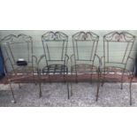 A set of 4 large wrought iron garden chairs.