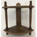 A vintage medium oak 2 tier corner shelf with turned detail to columns.