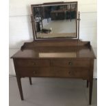 A 3 drawer dressing table with gallery back and swing mirror by Waring & Gillow.