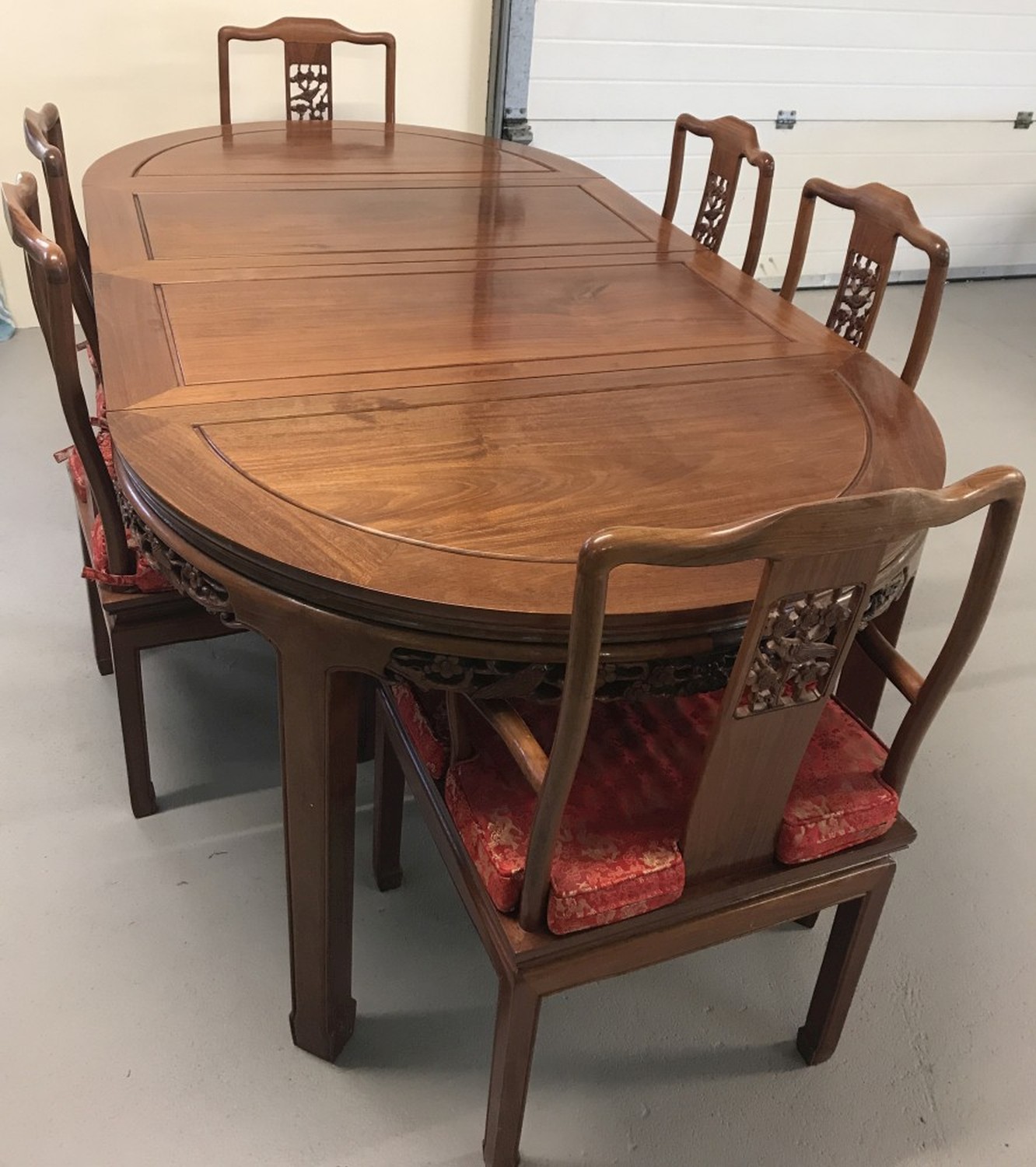 A large solid wood Oriental carved draw leaf dining table and 6 chairs.