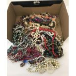 A box of vintage plastic and wooden bead necklaces.