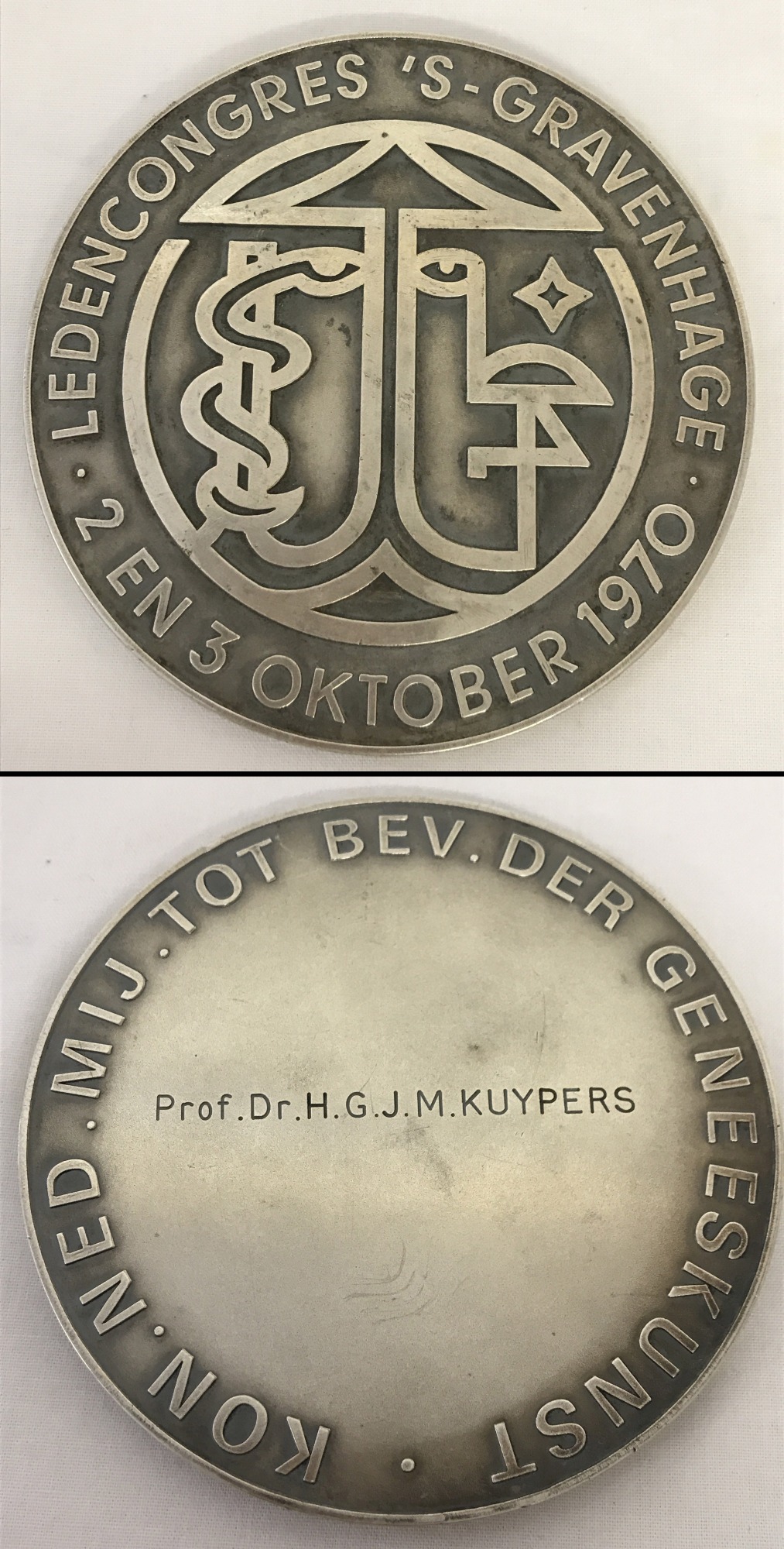 A large white metal medallion awarded for medical research.